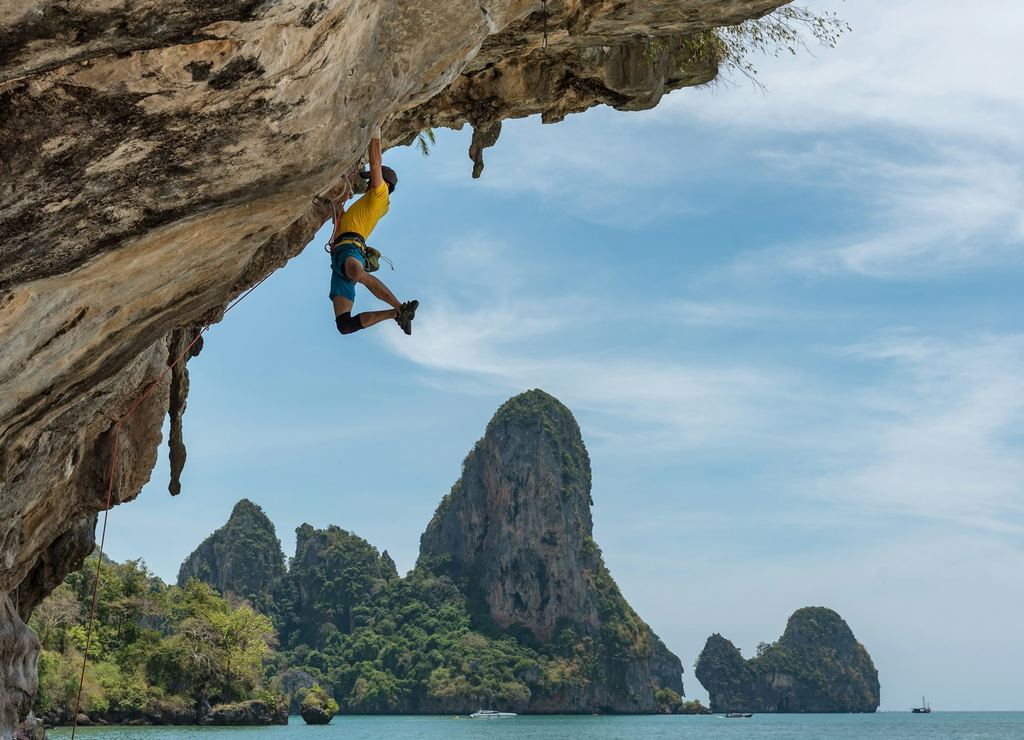 Mountain climber reaching summit - partnership to help you reach the top